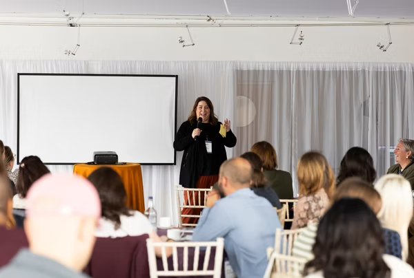 Laura speaking on stage